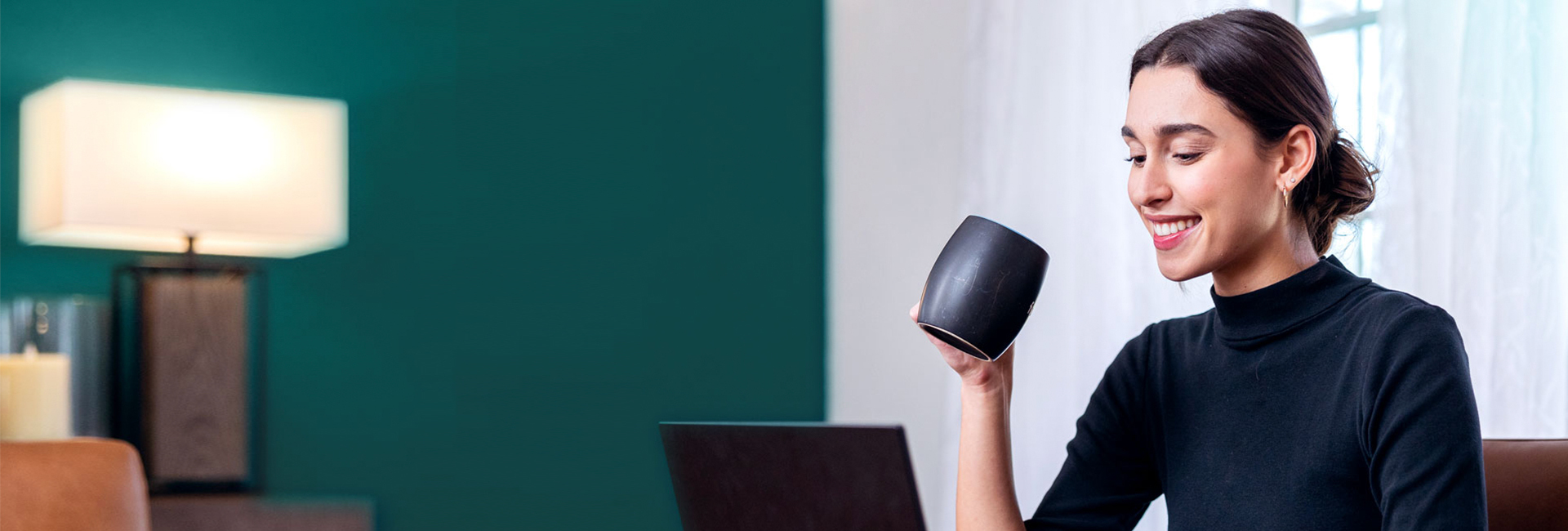 Woman on laptop with a coffee